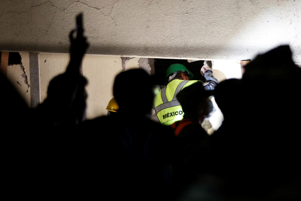 <p>A rescue worker searches through rubble in a floodlit search for students at Enrique Rebsamen school in Mexico City, Mexico Sept. 20, 2017. (Photo: Carlos Jasso/Reuters) </p>