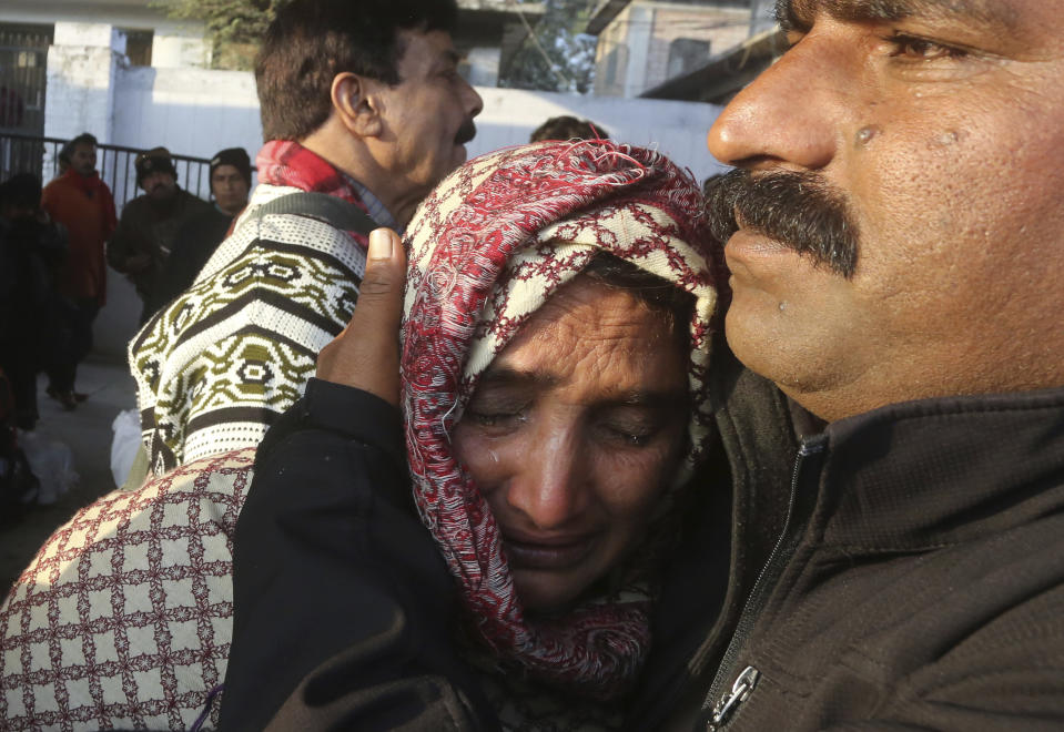 A Pakistani man, right, hugs his Indian relative who is preparing to return to India, after being stranded in Pakistan for a week, at Lahore Railway Station in Pakistan, Monday, March 4, 2019. A Pakistani railways official says a key train service between Pakistan and neighbouring India has been resumed, a sign on easing tensions between the two South Asian nuclear-armed rivals. (AP Photo/K.M. Chaudary)