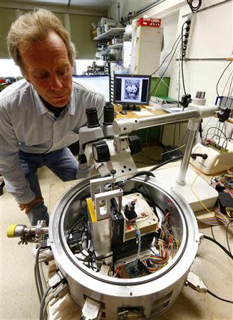 Physicist Urs Duerig looks at a prototype of an IBM NanoFrazor 3D nano printing tool at a laboratory of IBM Research in Rueschlikon, near Zurich, April 23, 2014. REUTERS/Arnd Wiegmann