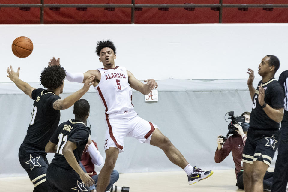 Alabama guard Jaden Shackelford (5) gets a pass away while falling out of bounds against Vanderbilt during the first half of an NCAA basketball game on Saturday, Feb. 20, 2021, in Tuscaloosa, Ala. (AP Photo/Vasha Hunt)