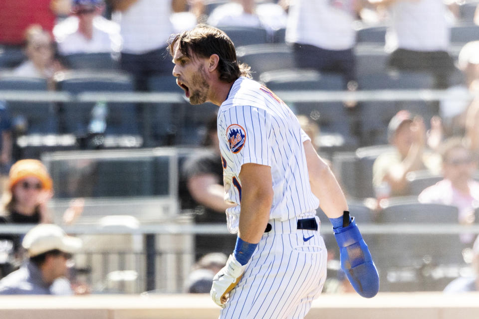 New York Mets' Jeff McNeil screams after scoring during the fourth inning of a baseball game against the Philadelphia Phillies, Sunday, Aug. 14, 2022, in New York. (AP Photo/Julia Nikhinson)