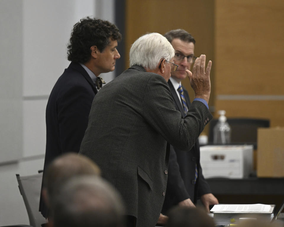 Thomas Martens, center, stands with attorneys Jones Byrd, left, and Jay Vannoy as he swears on a Bible, pleading guilty to voluntary manslaughter during a hearing, Monday, Oct. 30, 2023, for Martens and his daughter, Molly Corbett, in the 2015 death of Molly's husband, Jason Corbett at the Davidson County Courthouse in Lexington, N.C. (Walt Unks/The Winston-Salem Journal via AP, Pool)