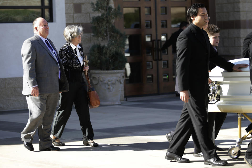 In this Friday, Jan. 10, 2014 photo, Paul and Roonie Cortez, parents of Mikey Cortez, follow the casket of their son after his funeral service, in Murietta, Calif. As his 7-year-old son Mikey lay in a hospital bed on life support, the victim of a drunk driver who had smashed into the car he was riding in, Paul Cortez took the boy's hand and made a solemn promise to God: If his son survived, no matter in what condition, he and his family would always be there for him.Although he would never emerge from the persistent vegetative state his father had found him in that night, Mikey’s family was not only there for him but also gave him a full life. A life, as it turned out, not all that different from anybody else’s, with cross-country family vacations and visits to Disneyland. (AP Photo/Jae C. Hong)