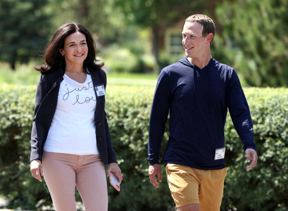 Facebook chief executive Mark Zuckerberg walks with former Facebook chief operating officer Sheryl Sandberg after a session at the Allen & Company Sun Valley Conference on 8 July 2021 in Sun Valley, Idaho (Getty Images)