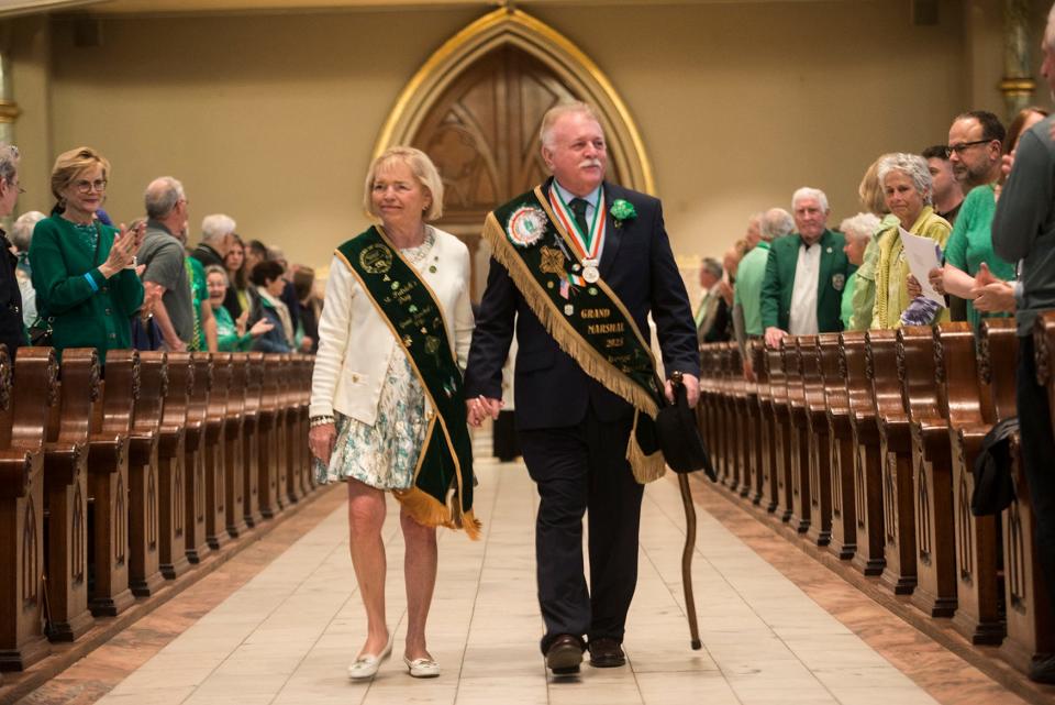 St. Patrick's Day Parade Committee Grand Marshal George Schwarz III and his wife Patricia Hodges Schwarz enter the Cathedral Basilica of St. John the Baptist for St. Patrick's Day Mass.