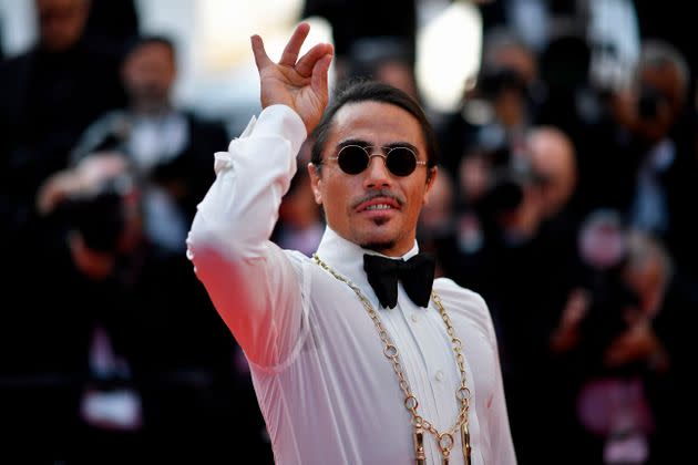 Turkish restaurateur Nusret Gokce, aka Salt Bae, has become legendary for his salting pose. Here, he does it on the red carpet at the Cannes Film Festival in 2019, even though there's no salt in sight. (Photo: CHRISTOPHE SIMON via Getty Images)