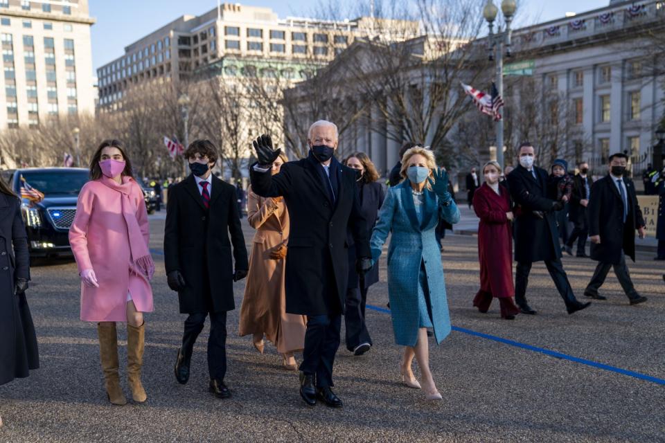 President Biden and First Lady Dr. Jill Biden walk along Pennsylvania Avenue.