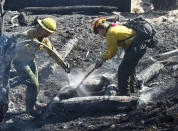 <p>Firefighters from Utah Division of Forestry, Fire and State Lands work on hot spots from yesterday’s fire in Moab, Utah. Wednesday, June 13, 2018. (Photo: Rick Egan/The Salt Lake Tribune via AP) </p>