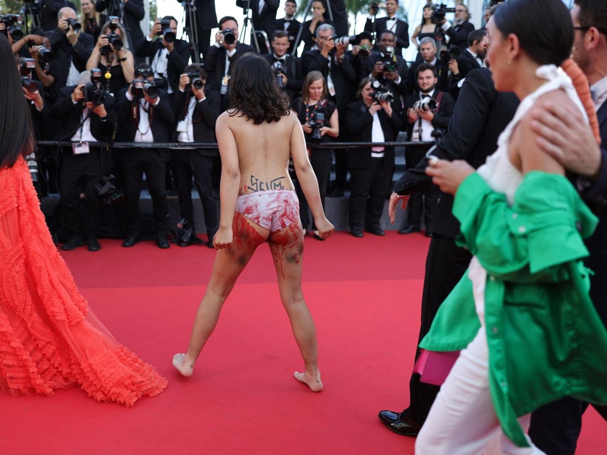 A protester on the red carpet at the 75th edition of the Cannes Film Festival in Cannes, southern France, on May 20, 2022.