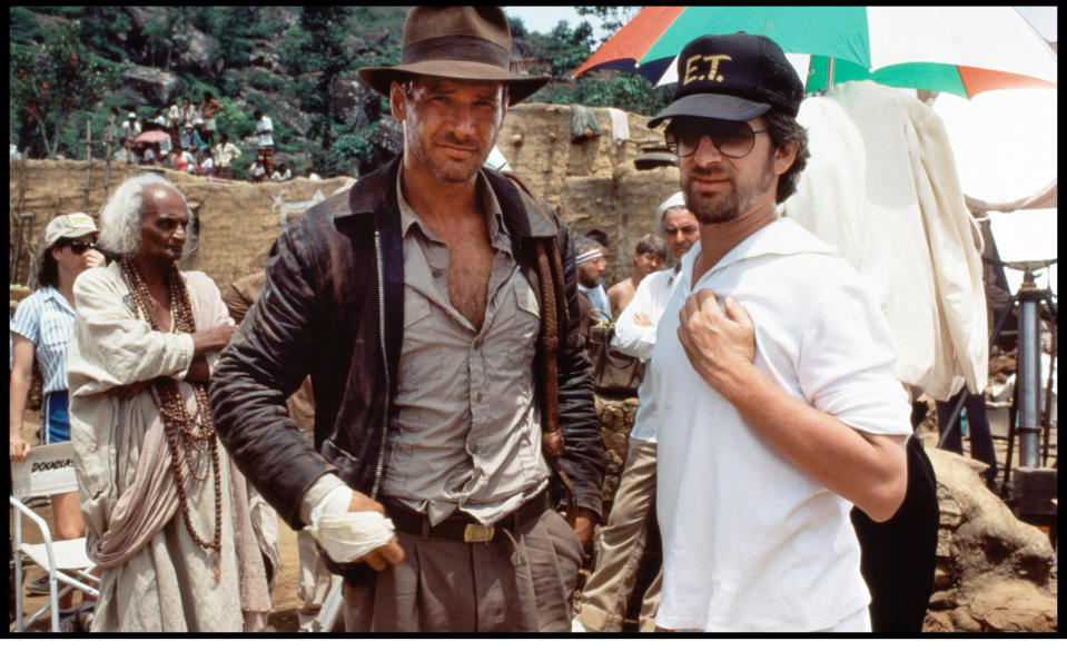 Harrison Ford with Steven Spielberg on the set of 1984's Temple of Doom. Spielberg later admitted he was 'in a dark place' while making the second Indiana Jones film. (Alamy)