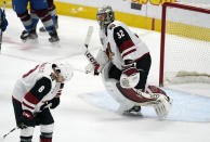 Arizona Coyotes center Nick Schmaltz, left, and goaltender Antti Raanta react after Colorado Avalanche left wing Gabriel Landeskog scored the winning goal in overtime of an NHL hockey game Wednesday, March 10, 2021, in Denver. The Avalanche won 2-1. (AP Photo/David Zalubowski)