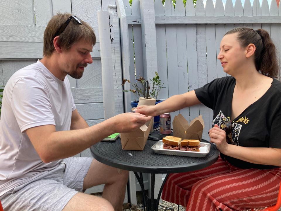 Billy Post and Ayse Bayar of Burlington enjoy a meal May 20, 2022 at Maudite Poutine. Post makes Hand Forged Hot Sauce that's available for use at the Burlington restaurant.