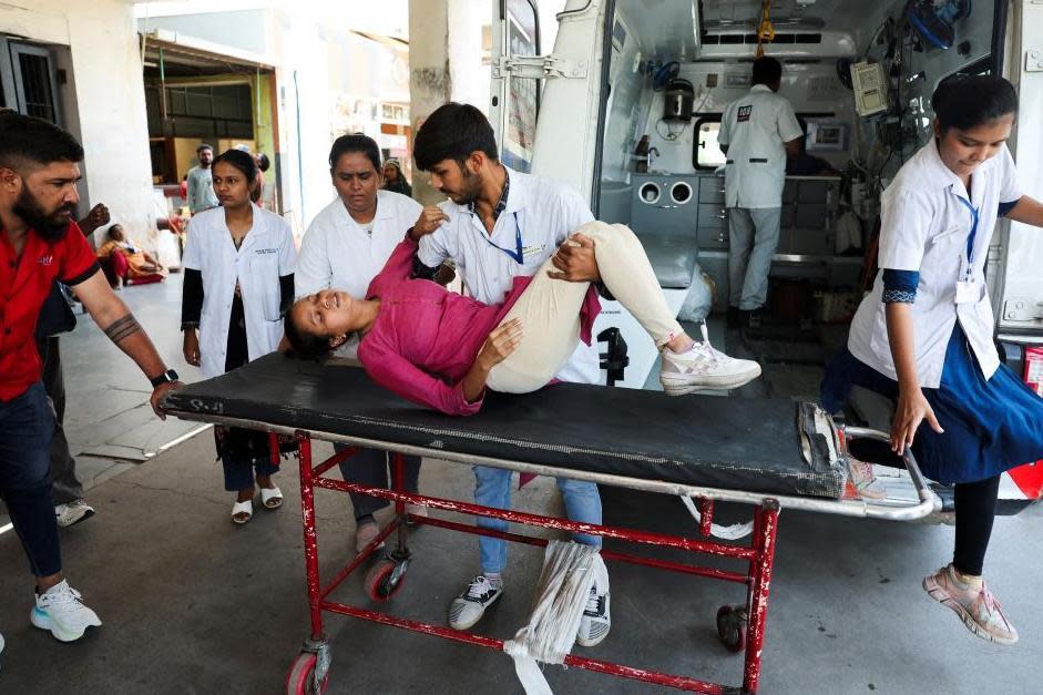 riyanshi Fakirbhai Patel, 20, who according to medical staff suffers from heat exhaustion, is helped by medical staff at the hospital during a heatwave in Ahmedabad, India, May 24, 2024. REUTERS/Amit Dave
