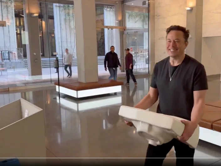 Elon Musk is shown carrying a sink into Twitter's headquarters in San Francisco