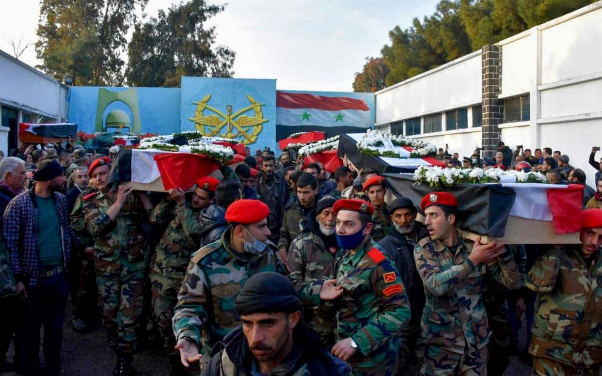 Mourners carry the coffins of Syrian army soldiers following the blast in late December - AFP via Getty Images