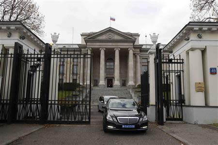 Vehicles drive out of the main entrance of the Russian embassy compound in Warsaw, November 12, 2013. REUTERS/Kacper Pempel