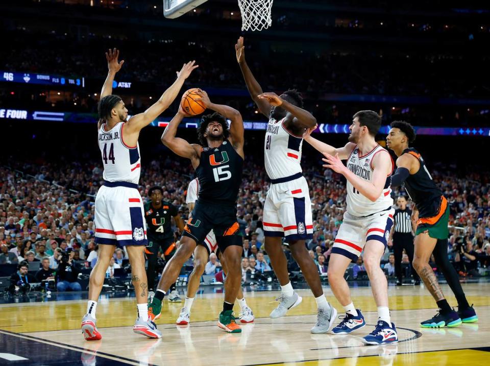 Connecticut Huskies guard Andre Jackson Jr. (44) and Huskies forward Adama Sanogo (21) defend Miami Hurricanes forward Norchad Omier (15) during the second half of the Men’s Basketball Championship National Semifinal at NRG Stadium in Houston, Texas on Saturday, April 1, 2023.