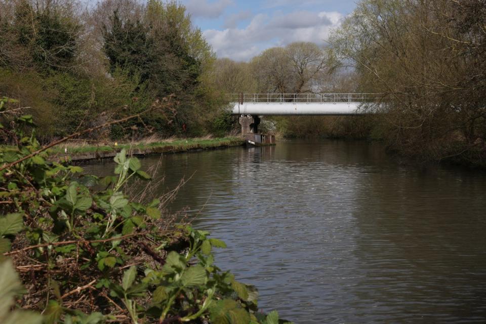 A sewage pipeline connected to Thames Water's Maple Lodge Sewage Treatment Works is seen over the River Colne near Maple Cross (REUTERS)