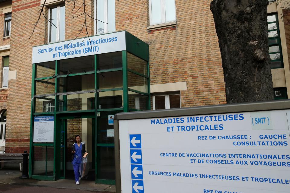 A medical staff leaves the department of Tropical Infections and diseases at the Bichat hospital, Wednesday, Jan. 29, 2020 in Paris.