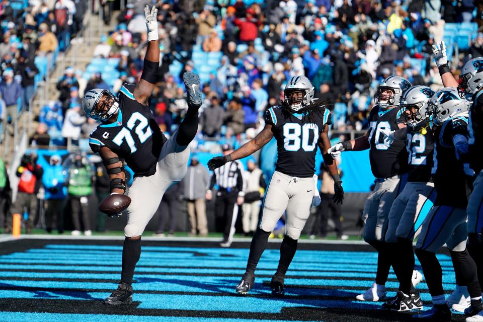 Carolina Panthers offensive tackle Taylor Moton celebrates after a touchdown by running back D'Onta Foreman during the first half of an NFL football game between the Carolina Panthers and the Detroit Lions on Saturday, Dec. 24, 2022, in Charlotte, N.C. (AP Photo/Jacob Kupferman)