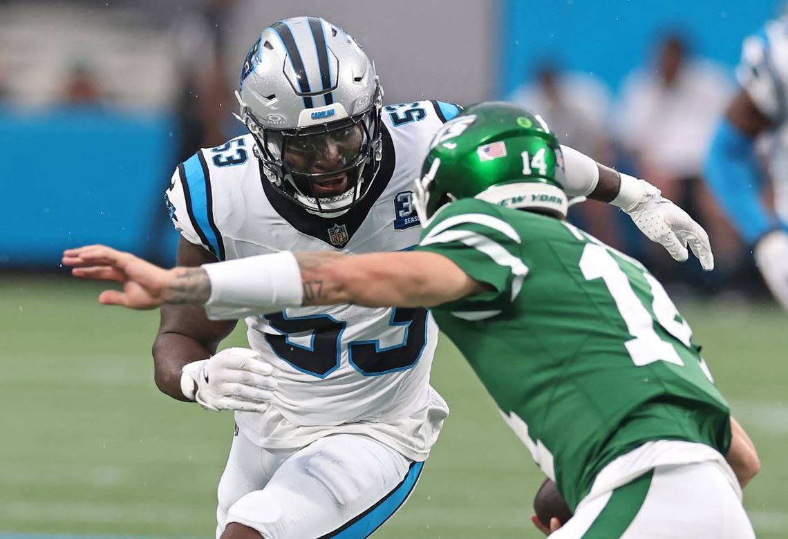 Carolina Panthers linebacker Claudin Cherelus, left, looks to make the tackle on New York Jets quarterback Andrew Peasley, right, on a run during first quarter action at Bank of America Stadium in Charlotte, NC on Saturday, August 17, 2024.