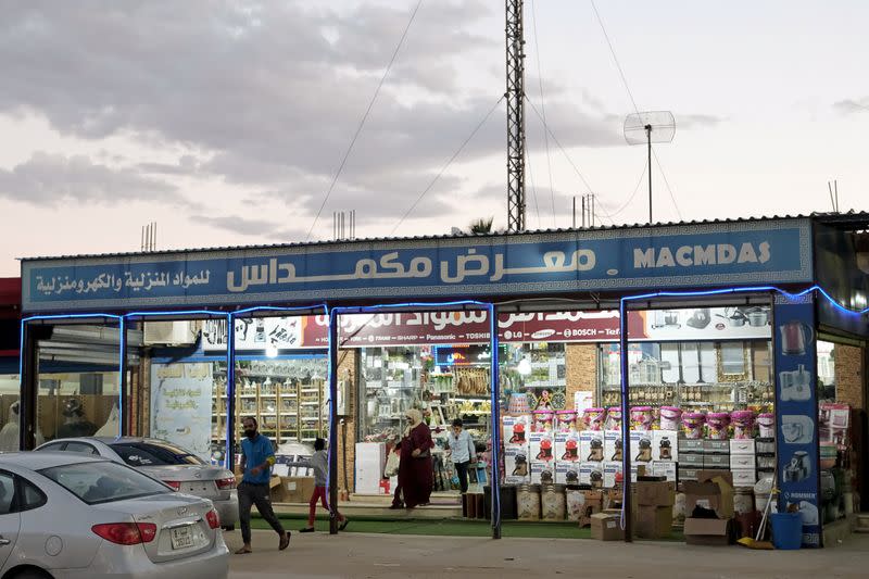People leave a store in Sirte