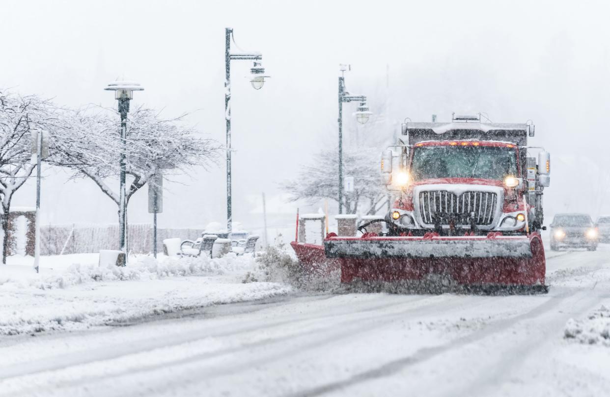 A plow truck clears Wisconsin Avenue in Pewaukee on Tuesday, Jan. 9, 2024.