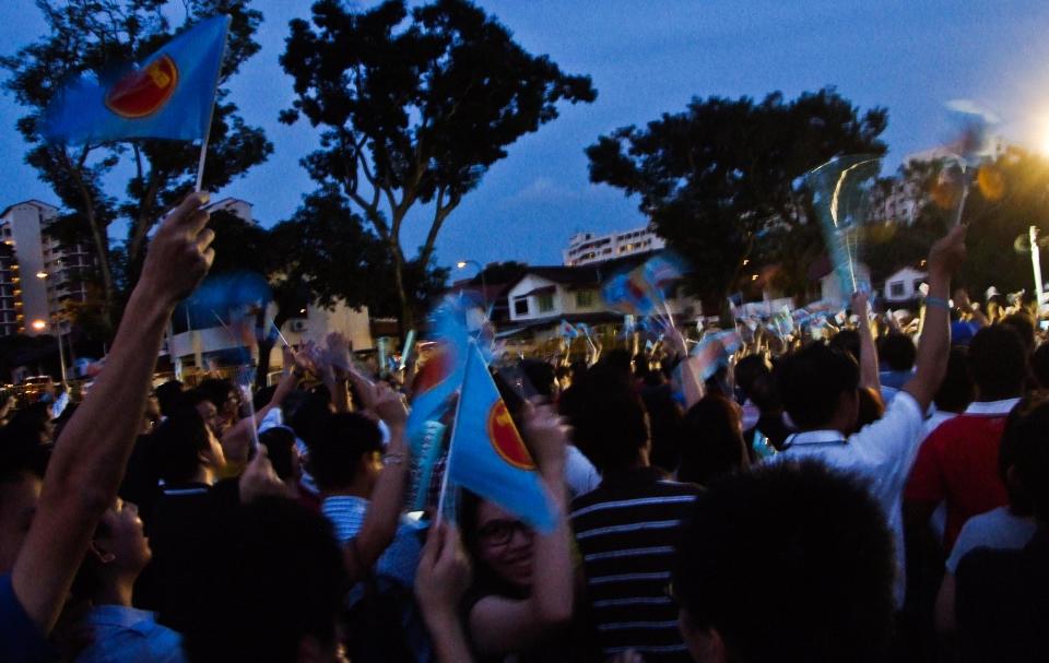 Workers' Party supporters wave their flags before the start of the rally at Hougang on Thursday, 28 April.(Yahoo! photo/ Quek Jan Yang) 