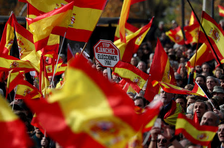 A man holds a placard reading "Stop Sanchez (referring to Spanish Prime Minister Pedro Sanchez) Elections now" during a gathering calling for Spanish unity at Colon Square in Madrid, Spain, December 1, 2018. REUTERS/Sergio Perez