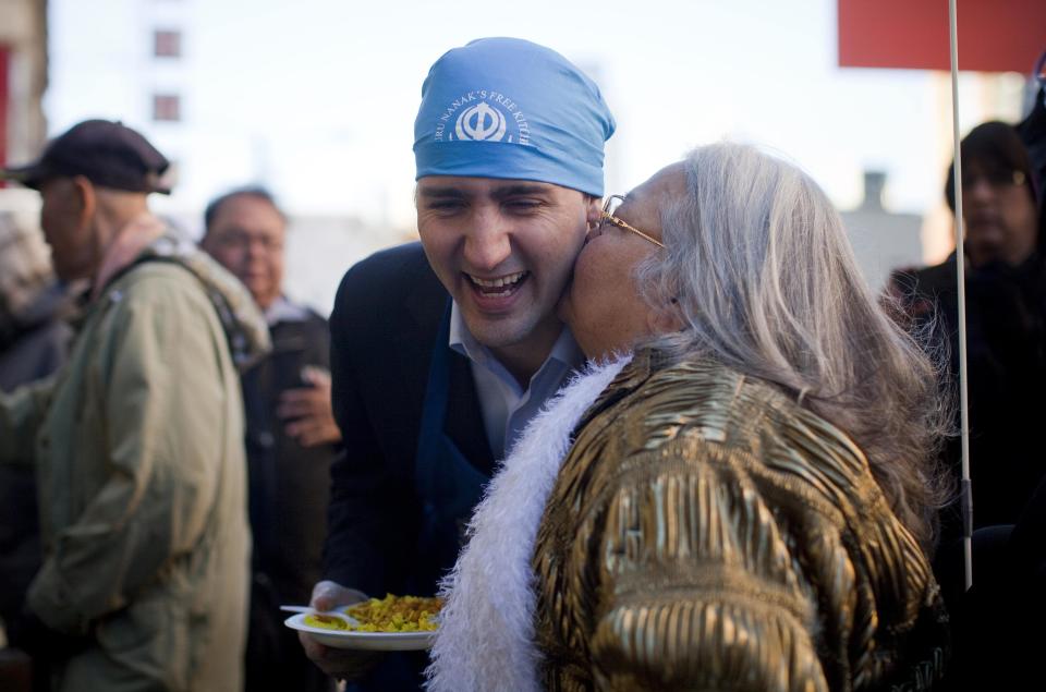 Leader of the Liberal Party of Canada MP Justin Trudeau gets a kiss from a woman in the downtown eastside neighbourhood in Vancouver.