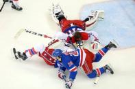 May 8, 2015; New York, NY, USA; New York Rangers left wing Chris Kreider (20) and Washington Capitals defenseman Brooks Orpik (44) collide over Washington Capitals goalie Braden Holtby (70) during the second period of game five of the second round of the 2015 Stanley Cup Playoffs at Madison Square Garden. Mandatory Credit: Brad Penner-USA TODAY Sports