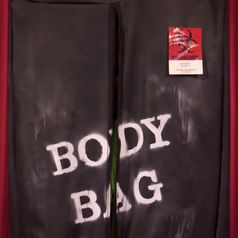 A body bag entering the Werk Room