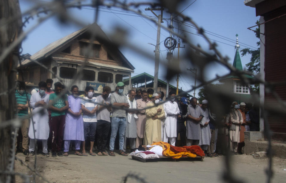 Relatives and neighbors offer funeral prayers near the body Bashir Ahmad, a civilian killed in a shootout, during his funeral at Sopore, 55 kilometers (34 miles) north of Srinagar, Indian controlled Kashmir, Saturday, June 12, 2021. Two civilians and two police officials were killed in an armed clash in Indian-controlled Kashmir on Saturday, police said, triggering anti-India protests who accused the police of targeting the civilians. (AP Photo/Mukhtar Khan)