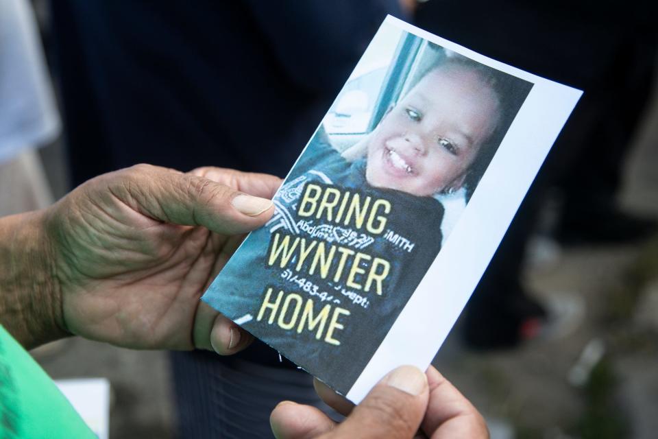 A flyer is handed out to community members who attend the vigil in memory of Wynter Cole-Smith on Friday, July 7, 2023, on Erwin Avenue near the body of the 2-year-old Lansing toddler was found in Detroit.