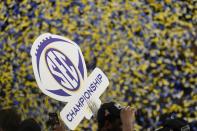 Alabama players hold a championship sign after the Southeastern Conference championship NCAA college football game between Georgia and Alabama, Saturday, Dec. 4, 2021, in Atlanta. Alabama won 41-24. (AP Photo/Brynn Anderson)