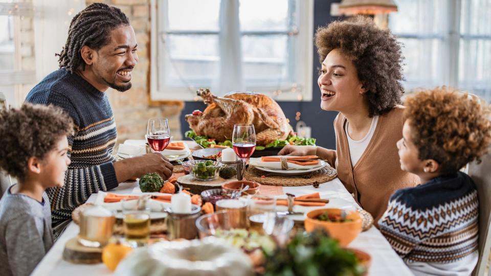 family talking during thanksgiving meal at dining table