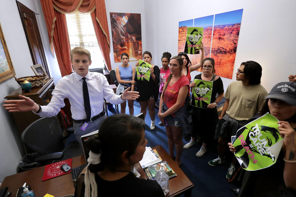 <p>A staff member asks journalists to leave as demonstrators from Arizona chant, “Kill the bill or lose your job” in the offices of Sen. Jeff Flake (R-AZ) during a protest against health care reform legislation in the Russell Senate Office Building on Capitol Hill July 10, 2017 in Washington, D.C. (Photo: Chip Somodevilla/Getty Images) </p>