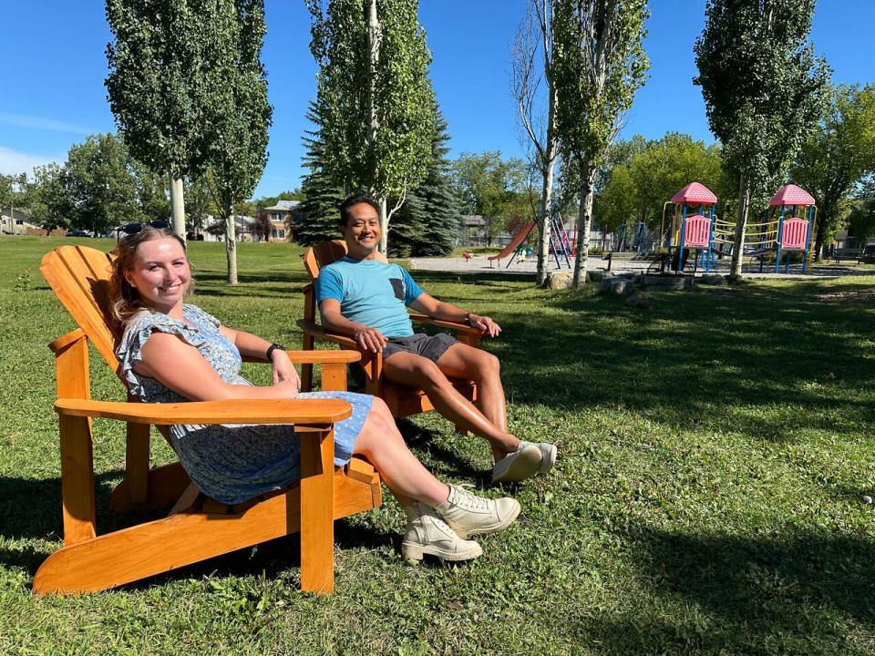 Julie Patton, left, and Thomas Mo sit on the new Adirondack chairs the Killarney-Glengarry Community Association placed in several parks throughout their neighbourhood.