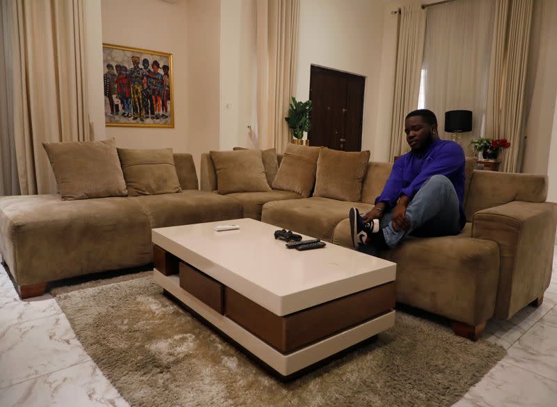 Ozioma Egemasi, a music administrator who says he has experienced police harassment, wears his shoes as he prepares to go out to join a protest over police brutality in Lagos