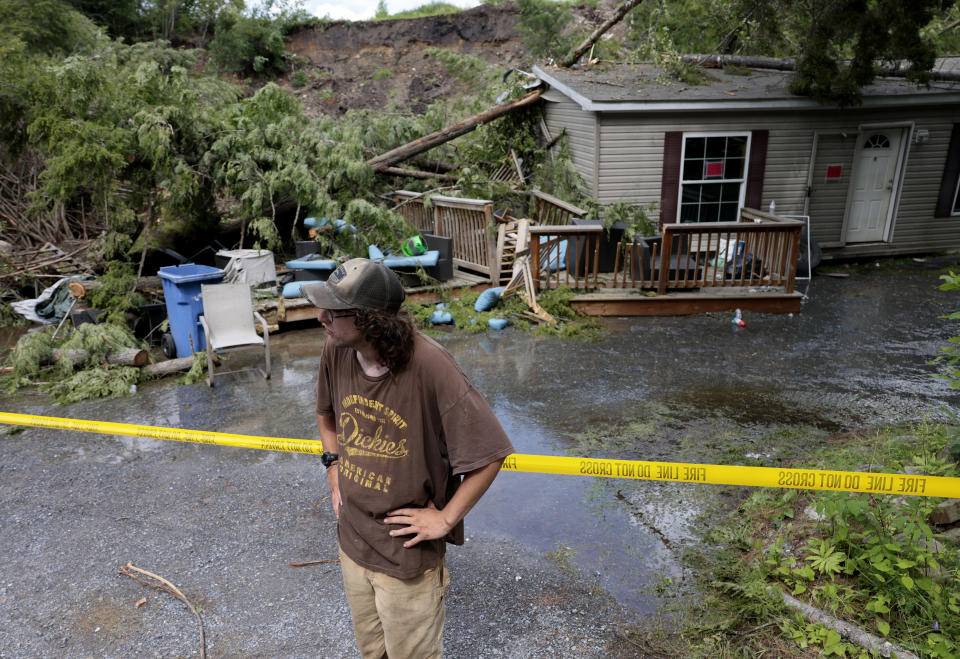 Ethan Poploski in front of his family's home