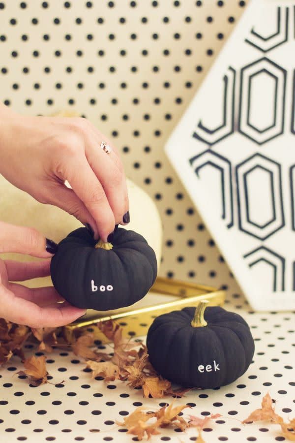 <p>Make your tiny pumpkins even cuter by painting them black and writing spooky sayings on them with a <a href="https://www.amazon.com/gp/product/B0013JTI00/?tag=syn-yahoo-20&ascsubtag=%5Bartid%7C10055.g.1714%5Bsrc%7Cyahoo-us" rel="nofollow noopener" target="_blank" data-ylk="slk:paint pen;elm:context_link;itc:0;sec:content-canvas" class="link ">paint pen</a>. </p><p><em><a href="https://lovelyindeed.com/diy-tiny-message-pumpkins/" rel="nofollow noopener" target="_blank" data-ylk="slk:Get the tutorial at Lovely Indeed »;elm:context_link;itc:0;sec:content-canvas" class="link ">Get the tutorial at Lovely Indeed »</a></em></p>