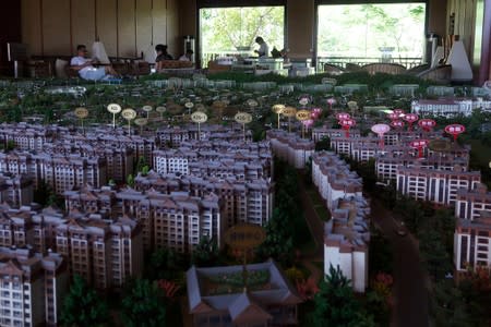 Model showing property project "Yulinyuanzhu" developed by Shanghai Red Star Macalline Real Estate Group is seen at a showroom in Xishuangbanna, Yunnan