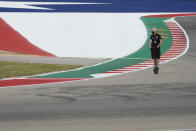 A Mercedes crew member rides the course before the Formula One U.S. Grand Prix auto race at the Circuit of the Americas, Thursday, Oct. 21, 2021, in Austin, Texas. (AP Photo/Nick Didlick)