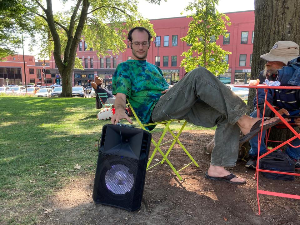 Matthew Fiducia, 31, ques up the next song on his speaker. Fiducia was homeless for 10 years but now is housed. He doesn't blame the police officer who asked him to turn his music down. "Loosen up on one thing, the whole f---ing domino effect happens from that. You know, it's kind of dumb the society's gotten this way, but when you decide to turn a small college town into a large city, what do you think's gonna happen? You get City problems."