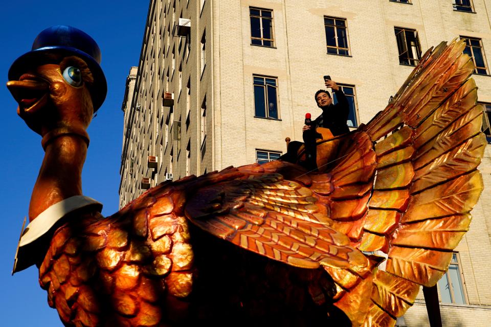 November 24, 2022: Mario Lopez takes photos from the Tom Turkey float at the Macy's Thanksgiving Day Parade.