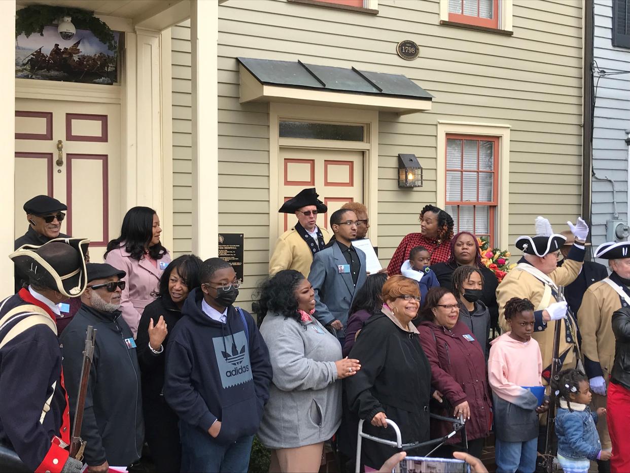 Descendants of decorated Revolutionary War soldier Oliver Cromwell and Colonial re-enactors gather outside what was his home at 114 E. Union Street in Burlington city,, where an historical marker was dedicated to the free Black soldier Wednesday by the daughters of the American Revolution.