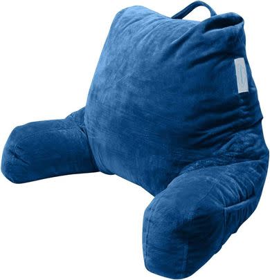 A colorful foam chair pillow with multiple pockets