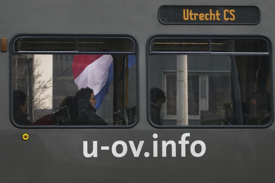 A tram passes a Dutch flag flying half-staff at the site of a shooting incident in a tram in Utrecht, Netherlands, March 19, 2019. (Photo: Peter Dejong/AP)