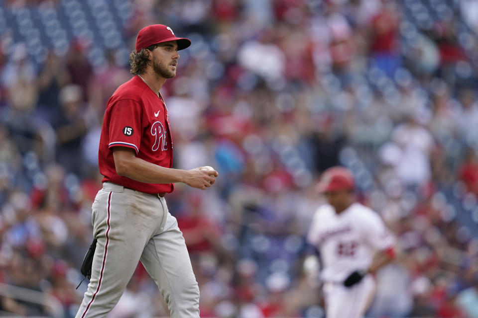 Philadelphia Phillies starting pitcher Aaron Nola walks to the mound as Washington Nationals' Juan Soto rounds the bases on Josh Bell's three-run home run in the fifth inning of a baseball game, Thursday, Aug. 5, 2021, in Washington. (AP Photo/Patrick Semansky)