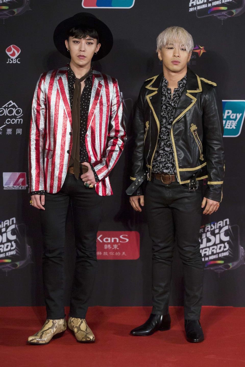 Members of South Korean K-Pop idol group Big Bang, Kwon Ji-yong, stage name G-Dragon and Dong Young-Bae, stage name Taeyang, pose on the red carpet as they attend the 2014 Mnet Asian Music Awards (MAMA) in Hong Kong